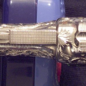 Note the taper of the barrel and the fine checkering on the top strap and top of the barrel.