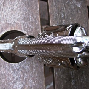 The top strap checkering was done prior to the engraving