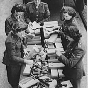 WWII British service women unpacking Lend Lease Victory revolvers.