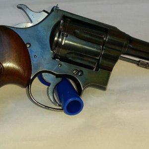 A 38 caliber Colt New Service that started as a fixed sight model with KING rear sight added. The grips are Sandersons'.