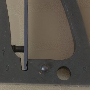 Factory refinish marks on the grip frame of a two tone (pinto) Pre-model 29, four screw revolver.  The mark on the right is a diamond followed by the 