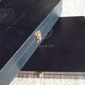 Picture of two .44 Magnum (Pre-model 29) four inch presentation cases.  The top case has the blue, pebble grain texture found only on cases shipped in