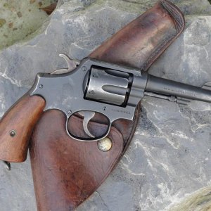 Smith & Wesson Victory model in .38 special that shipped in November of 1942.  This gun only has the V prefix, and the ordnance bomb for markings.  It