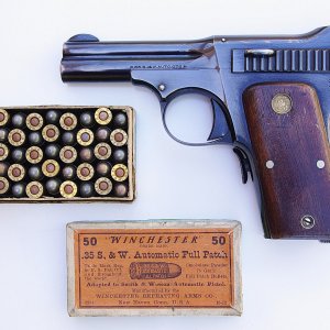This is the left side of a rare Model 1913 .35 Automatic with an even rarer full box of ammunition.   The ammo dates from October 1913, by the code on