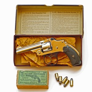 A mint-condition Safety Hammerless .32, vintage of 1921, with box and cartridges.